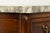 A late 18th-century French Louis XVI secrétaire à abattant crafted in walnut and topped with a gray and white veined...