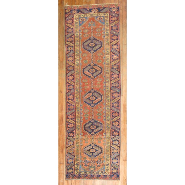A one of a kind decorative antique Persian Heriz runner. With distinctive large scale motifs and a wide ranging palette of...