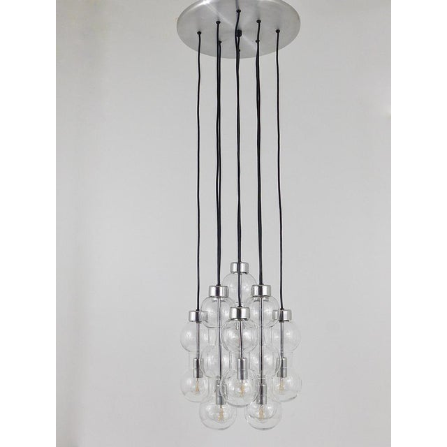 A beautiful large Cascade chandelier / pendant lamp from the 1960s, executed by Doria, Germany. This impressive chandelier...