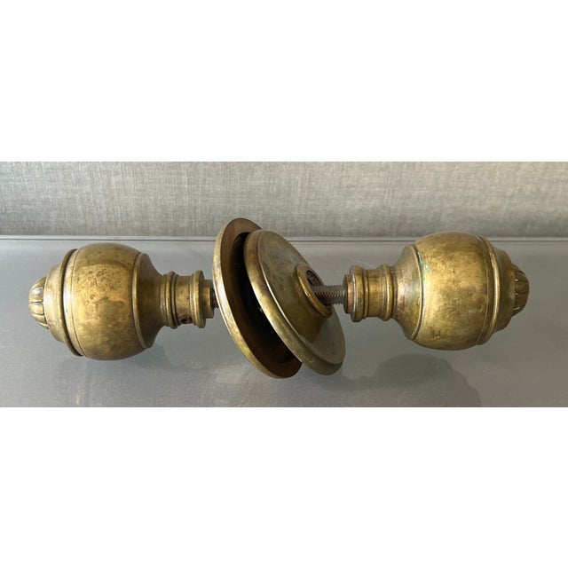 Antique 19th century brass door knob. Neoclassical taste with flower head design. Measures 9 1/4" long overall. Knob...