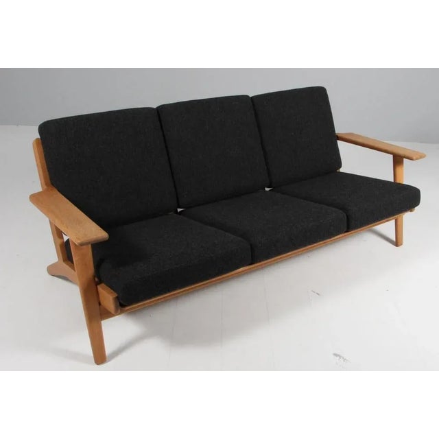 Hans J. Wegner three-seat sofa made of solid soap treated oak. New upholstered with Hallingdal 180 from Kvadrat Model 290,...