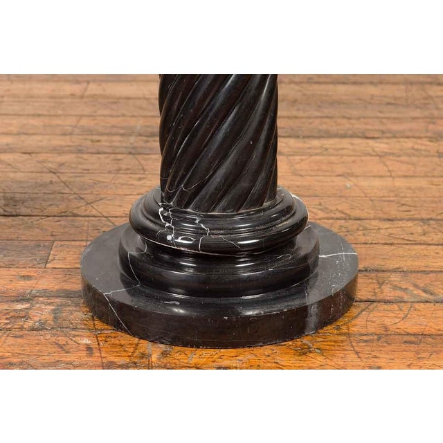 A pair of vintage Thai black Carrara marble pedestals with bronze Corinthian capitals and twisted columns. Created during...