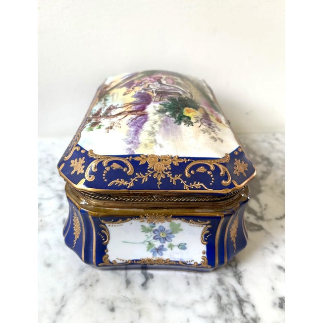 This beautiful box features hand-painted floral details, a hand-painted interior, and a courting scene on the lid. The...