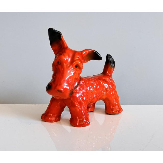 A lovingly crafted and hand-painted Art Deco scotch terrier figurine in porcelain. It is attributed to Ida-Erdös-Meisinger...