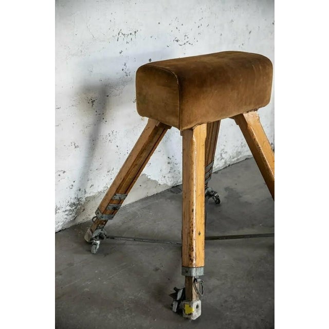 Vaulting horse with telescopic legs showing signs of years of use, usually moved on wheels, produced by Niels Larsen and...