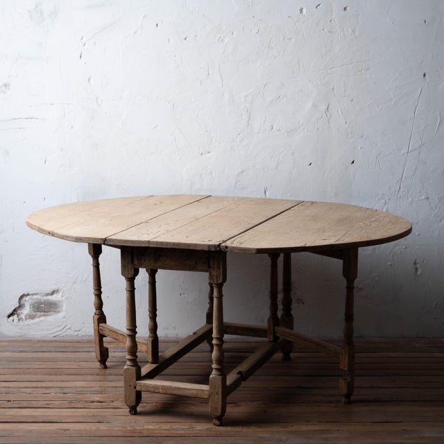 English oak gate-leg table, early 18th century, with a bleached finish and turned baluster legs. 46 inches wide by 20...