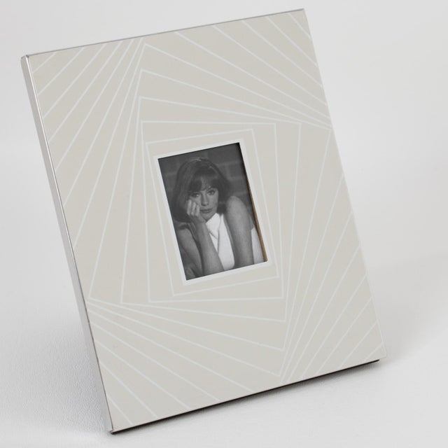 Italian designer Umberto Mascagni from Bologna designed this kinetic picture frame, circa 1970. The piece boasts silvered...