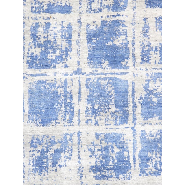 The Modern Collection explores hand-knotted design through abstract patterning, solid tonal fields, and subtle surface...