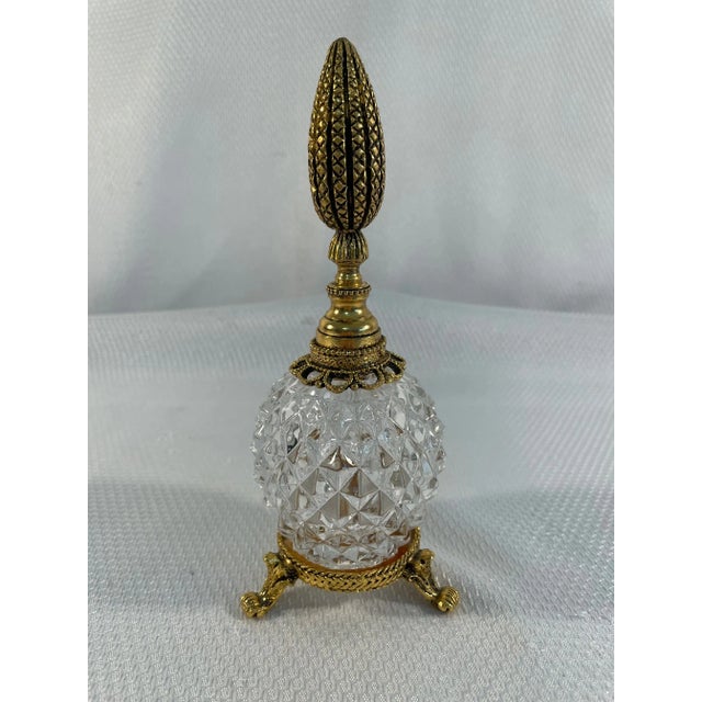 A gorgeous French Style Ormolu Cut Crystal Perfume Bottle with ornate dauber. Circa 1950-70s. This enchanting perfume...