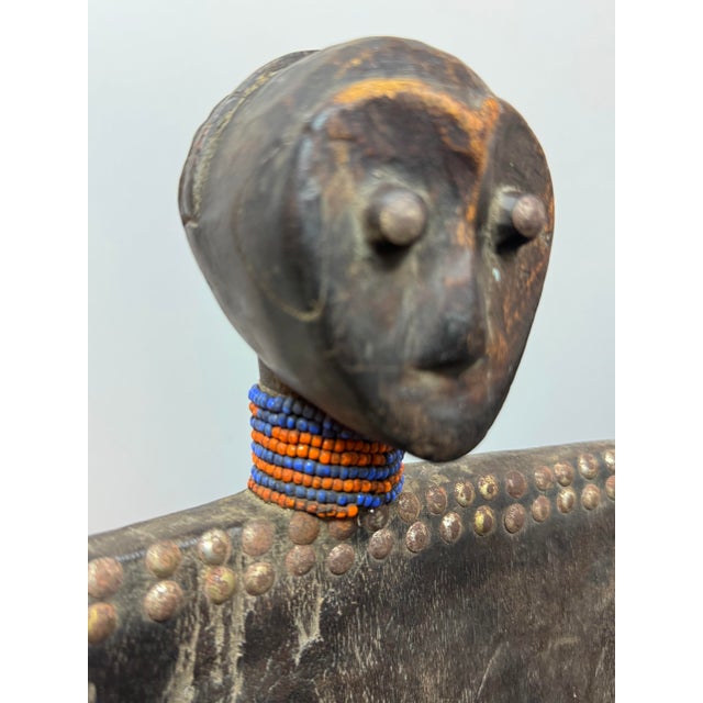 Exceptional African ceremonial tribal chair, likely originating from Tanzania. Carved from solid wood and featuring a...