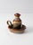 A vintage handmade studio pottery oil candle chamberstick finished in layered glazes of caramel brown, cream, deep blue,...