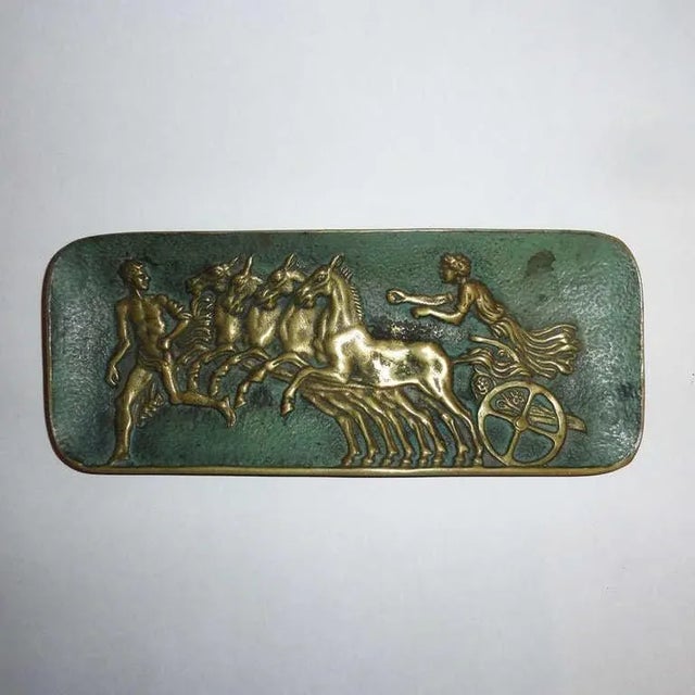 Bronze vide-poche and stamps box with double patina. Videpoche with low-relief decoration representing Hercules’s quadriga...