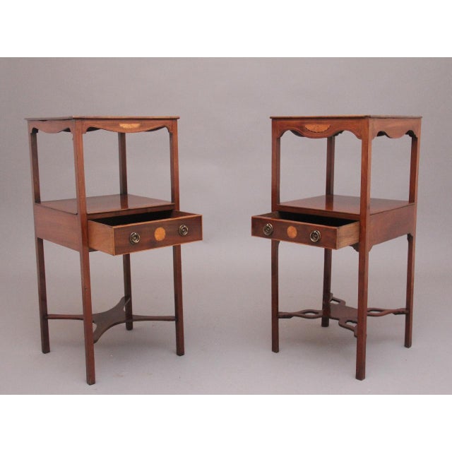 A near pair of early 19th Century inlaid mahogany bedside tables, having nice figured tops with a shaped frieze below with...