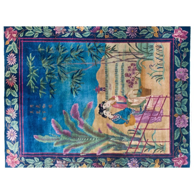 This early 20th-century Chinese Art Deco rug is a vibrant tableau of leisure, abundance, and artistic sophistication. Two...