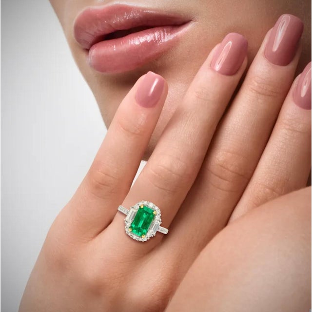2.22 carat natural Colombian Emerald and Diamond Ring. Centering a lustrous emerald-cut emerald, measuring 10.3 x 6 MM, a...
