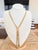 A substantial American Edwardian slide necklace, crafted in 14K yellow gold and weighing an impressive 56 grams. The...