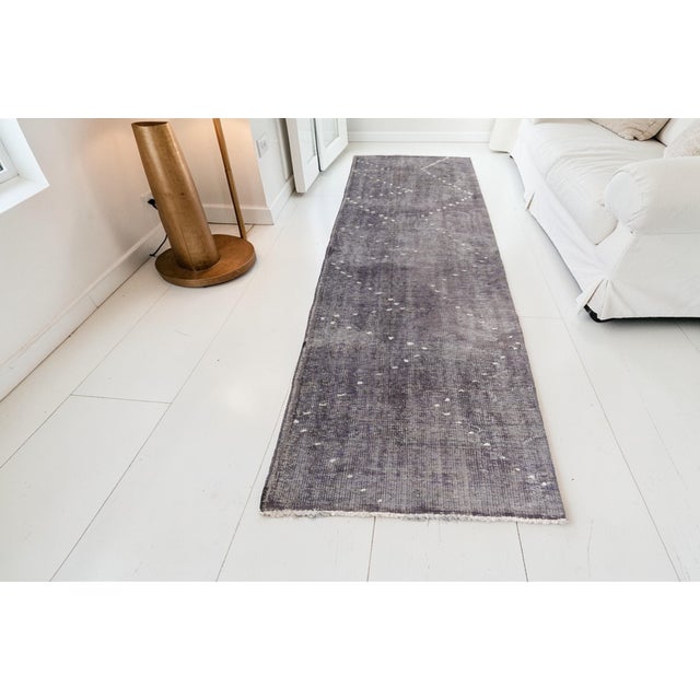 This is a vintage Turkish Oushak rug from the Mid 20th Century. The piece was hand-knotted.