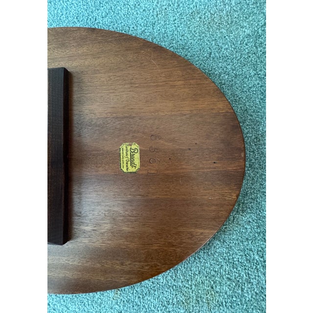 This beautiful vintage oval side table by Brandt features a classic pedestal base with a lower shelf. The piece has been...