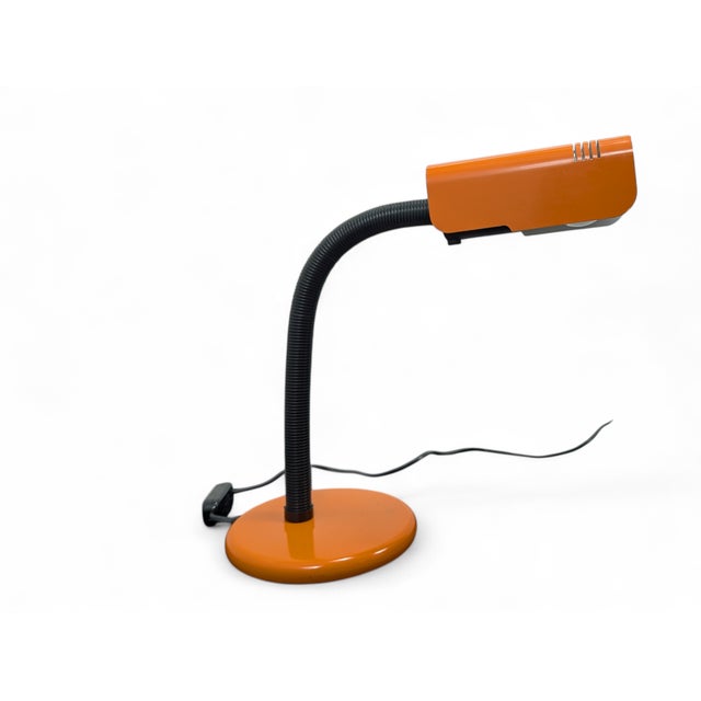 This Targetti table lamp is an icon of 1970s Italian design, characterized by a vibrant and functional Space Age...