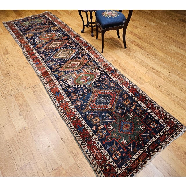 "An exceptional early 20th-century Persian Heriz Serapi runner, this piece showcases the distinctive geometric aesthetic...