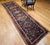 "An exceptional early 20th-century Persian Heriz Serapi runner, this piece showcases the distinctive geometric aesthetic...