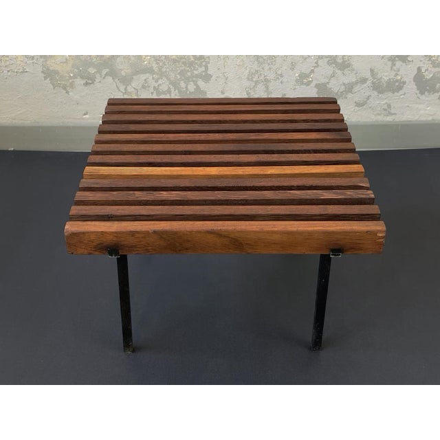 Minimalistic mid-century stool from teak and blackened metal. The solid slats are somewhat beautiful in colour, a...