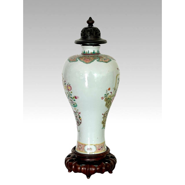An exceptional Chinese Famille Rose crisp white porcelain Mei Ping (Baluster) Vase presented on a hand carved rosewood...