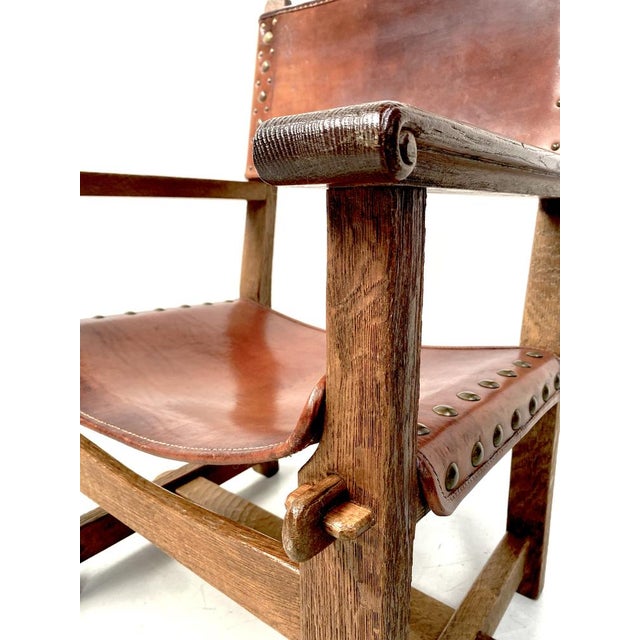 Antique Castle Chair in thick Cognac leather and oak wood. It was handmade in France in the late twenties. Handmade only...