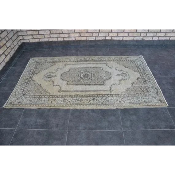 This is a vintage Turkish Oushak rug from the 1960s. The piece was hand-knotted.