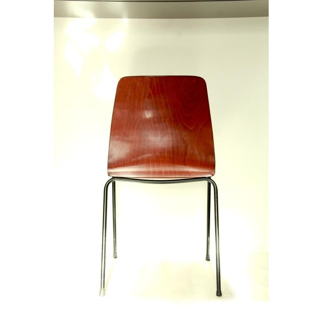 Scocca is an elegant chair realised by Pagholz in West Germany in 1956. This piece is made of solid black lacquered iron...