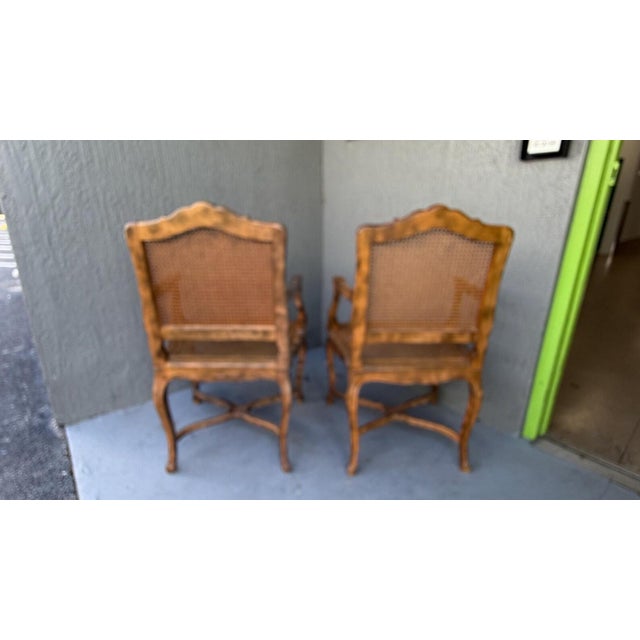 This is a gorgeous pair of vintage French armchairs. They feature beautiful carving and all cane seat and back. The color...