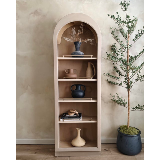 This thoughtfully refinished arched cabinet brings a timeless, elevated look to any space. It features a softly curved...