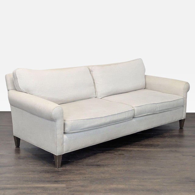 This Crate & Barrel 2-seat sofa features a simple and timeless design with a light beige fabric. It offers comfortable...