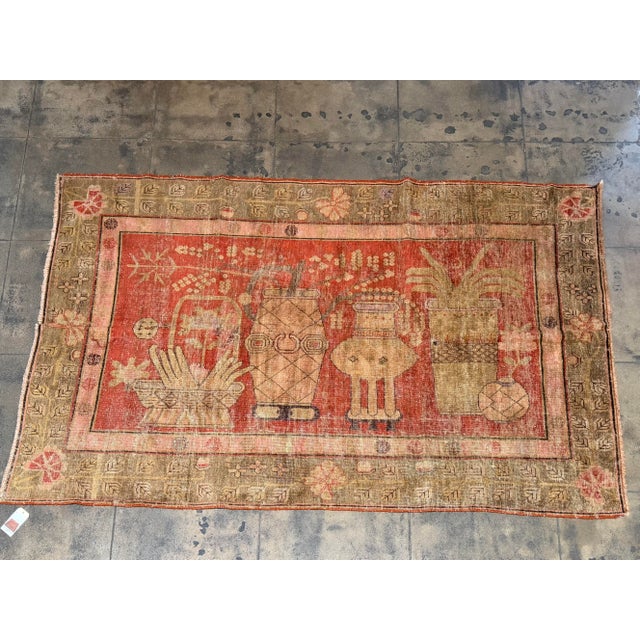 This distinctive antique Samarkand rug, dating to the early 1900s, features an unusual arrangement of ornamental vases,...