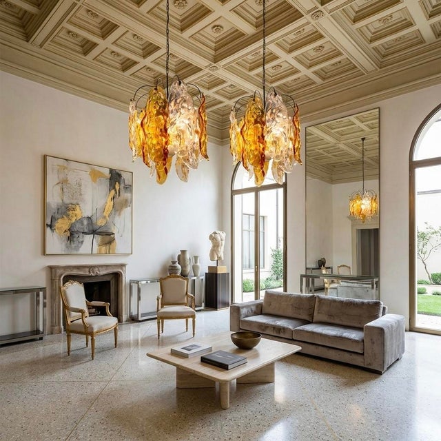 Glowing like golden leaves suspended in midair, this striking pair of Murano glass chandeliers captures the warmth and...