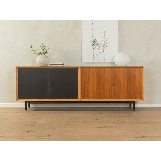 Classic sideboard from the 1960s. High-quality body in walnut veneer with two cabinet doors, two Formica-coated cabinet...