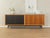 Classic sideboard from the 1960s. High-quality body in walnut veneer with two cabinet doors, two Formica-coated cabinet...