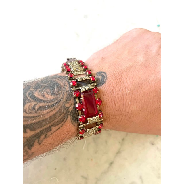 Stunning Art Deco bracelet. Ruby rhinestones color glass and silver metal.