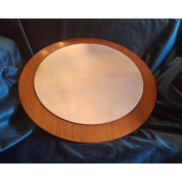 Mid century circular teak wall mirror, Denmark 1960s. Fine, narrow bevelled edge. (Light reflections on the bevelled edge,...