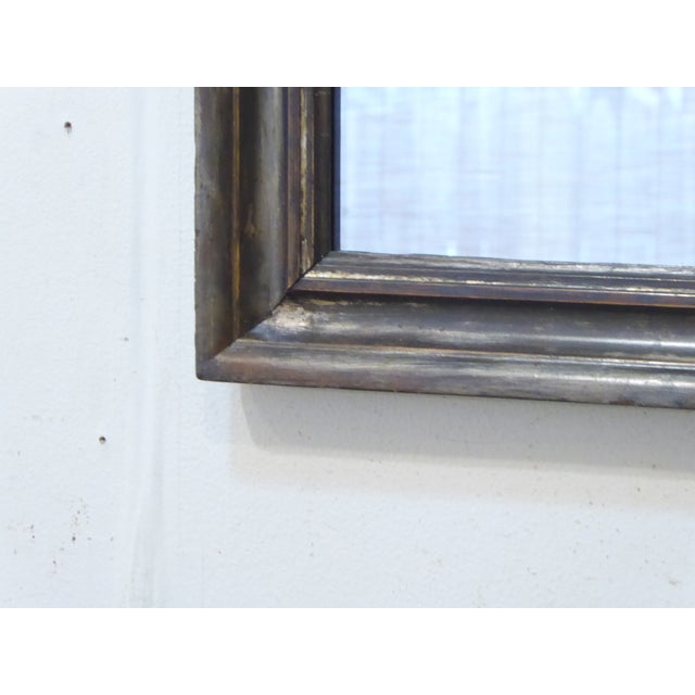 This silvered mirror has a dark pewter tone finish and measures 21.75"H x 16.75"W.