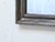 This silvered mirror has a dark pewter tone finish and measures 21.75"H x 16.75"W.