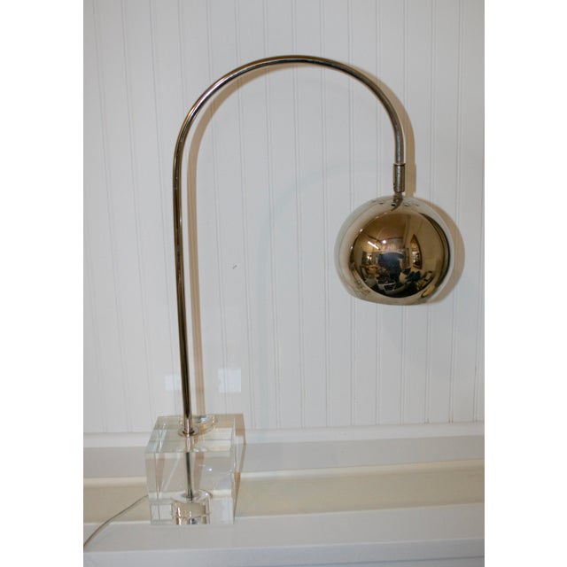 Stunning Mid-Century style chrome globe lamp. Features a gooseneck style body and a crystal base. This lamp is a Mid-...