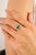 Crafted in luminous 14k yellow gold, this elegant ring showcases a captivating 1.06-carat emerald-cut emerald at its...
