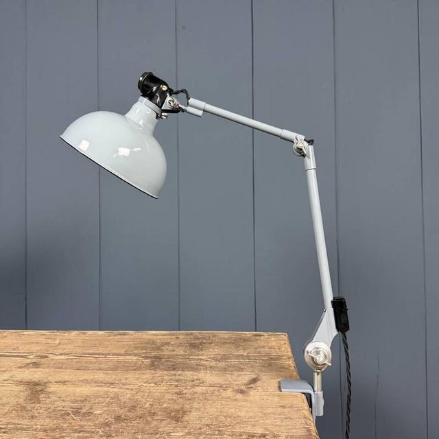 Light gray two-arm Rademacher clamp lamp with a large gray enamel lampshade from the 1950s. Rademacher was founded by...