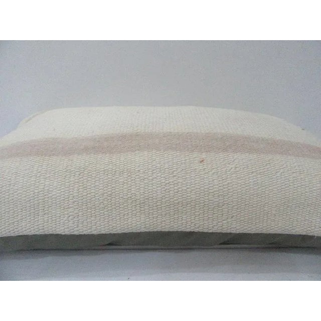 This is a pillow cover made from a vintage kilim rug. The piece was properly washed and ready to use. Pillow inserts not...