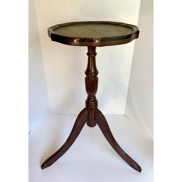 This versatile mid-20th century English wine/drinks table features a richly toned wood pedestal base and a beautifully...