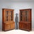Pair of rosewood veneered bookcases. The upper part features glass doors, embellished with leaf carvings and scrolls....