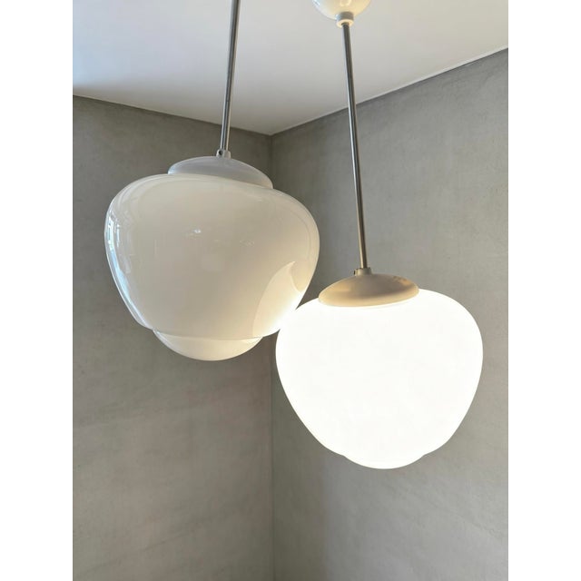 1960s large acorn shaped opaline pendant lights by czech light makers napako. napako is a historical czech lighting...