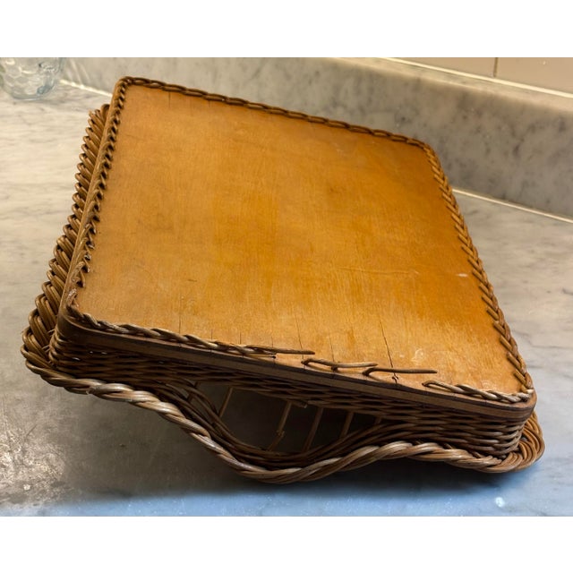 Beautifully crafted tray featuring hand woven wicker walls and warm honey-toned wood base. Braided trim displays hand...