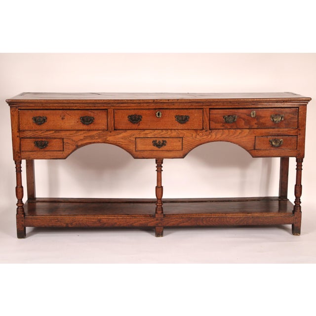 Antique Georgian oak sideboard, early 19th century. With a rectangular two board top with rounded front and side edges, 3...